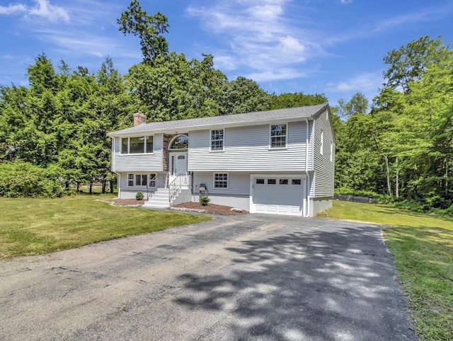 4 Gary Rd, Norton, MA 02766 - raised ranch with driveway, a chimney, a front lawn, and an attached garage
