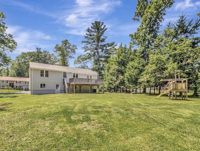4 Gary Rd, Norton, MA 02766 - view of grassy yard with stairs, a wooden deck, and a playground