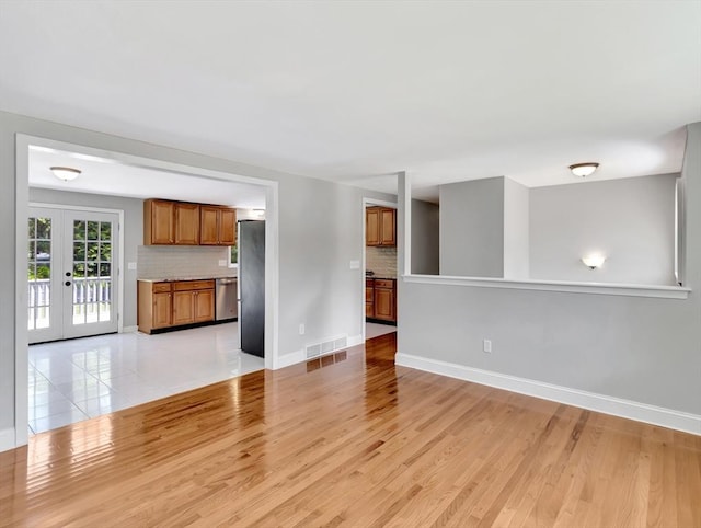 4 Gary Rd, Norton, MA 02766 - unfurnished living room with light wood finished floors and french doors