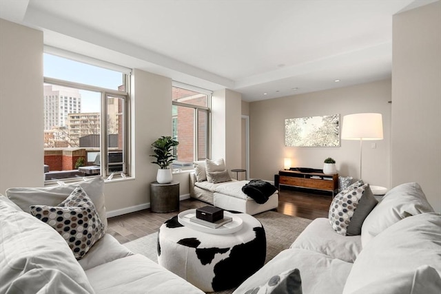 living area featuring baseboards, recessed lighting, and wood finished floors