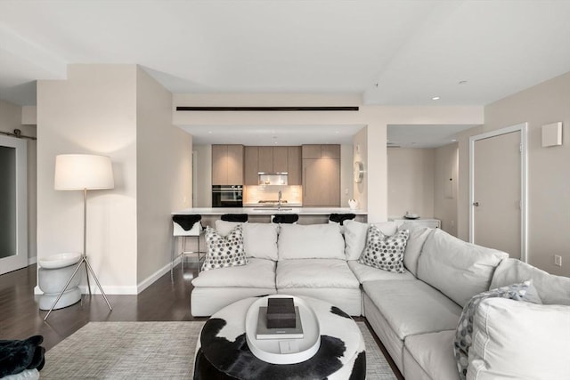 living area with baseboards and dark wood finished floors