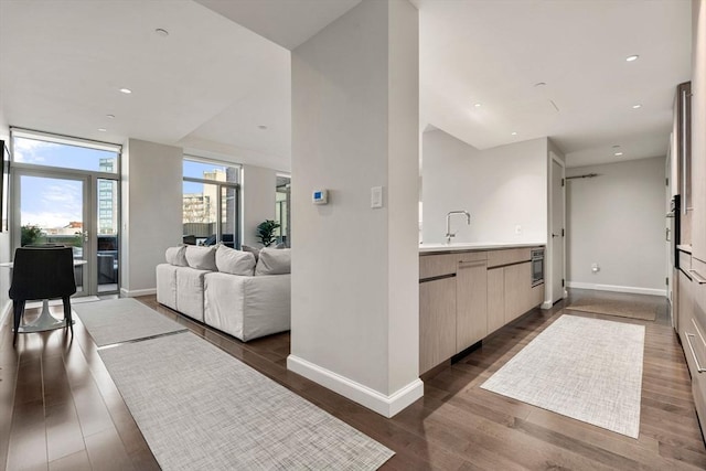 bathroom featuring baseboards, vanity, ensuite bath, and wood finished floors