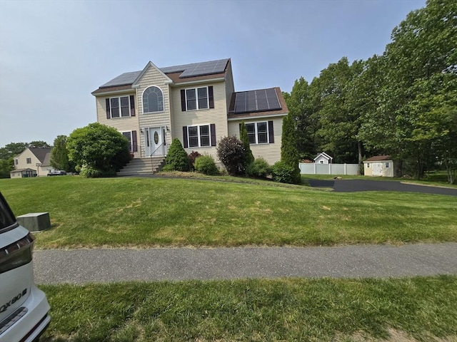 62 Saint Anthony St, Fitchburg, MA 01420 - colonial-style house featuring roof mounted solar panels and a front lawn