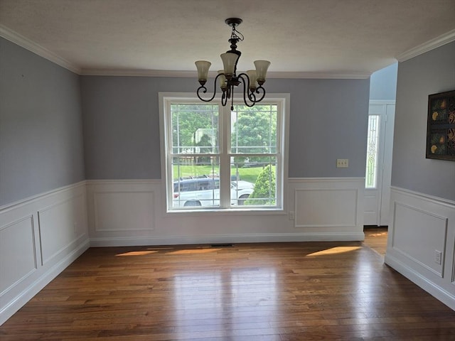 62 Saint Anthony St, Fitchburg, MA 01420 - unfurnished dining area with a chandelier, dark wood-style floors, a wainscoted wall, and crown molding