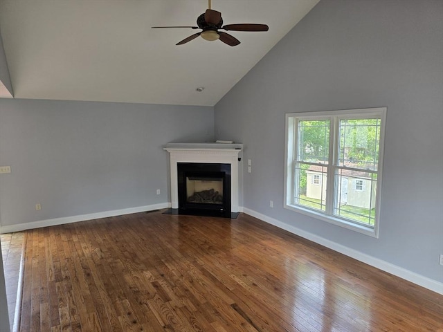 62 Saint Anthony St, Fitchburg, MA 01420 - unfurnished living room featuring dark wood-style floors, a ceiling fan, a fireplace with flush hearth, and high vaulted ceiling