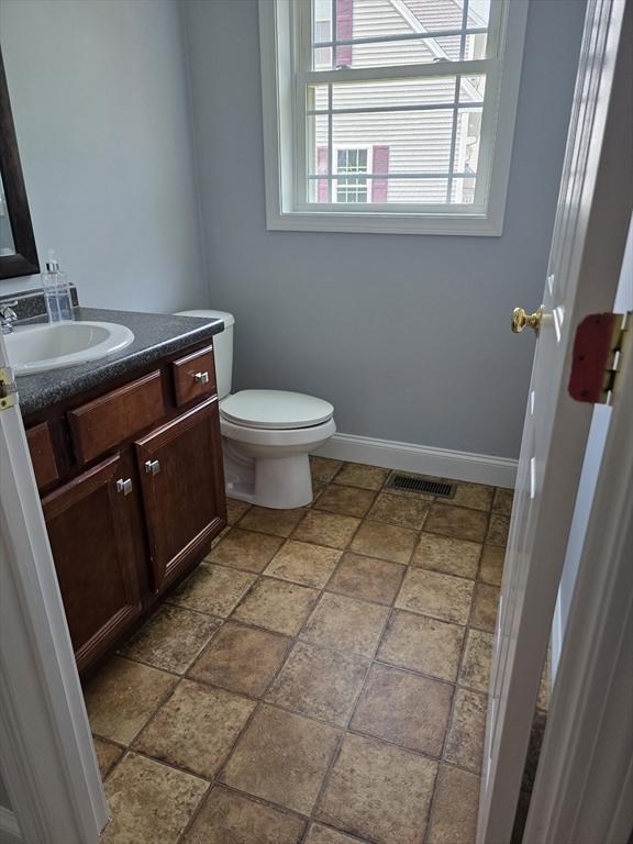 62 Saint Anthony St, Fitchburg, MA 01420 - half bath with vanity and stone finish floors