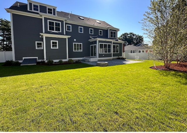 back of house with a lawn, a patio area, and a sunroom