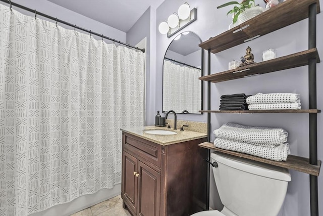 full bath featuring vanity, tile patterned floors, and toilet