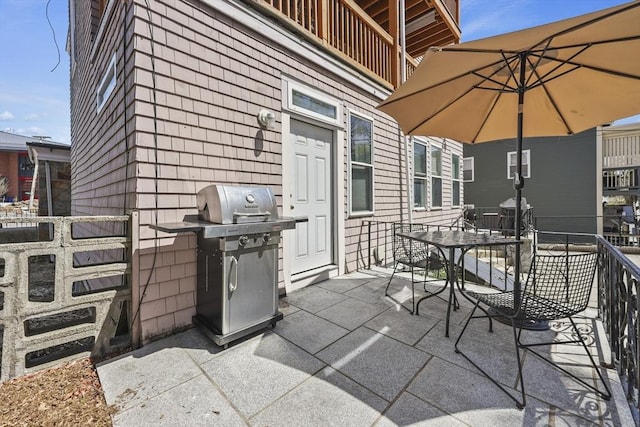 view of patio / terrace featuring outdoor dining area, cooling unit, a balcony, and a grill