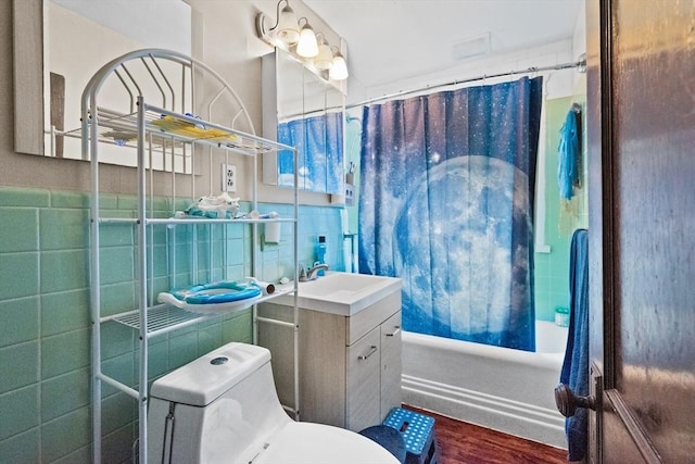 full bathroom with vanity, shower / bath combination with curtain, toilet, tile walls, and wood-type flooring