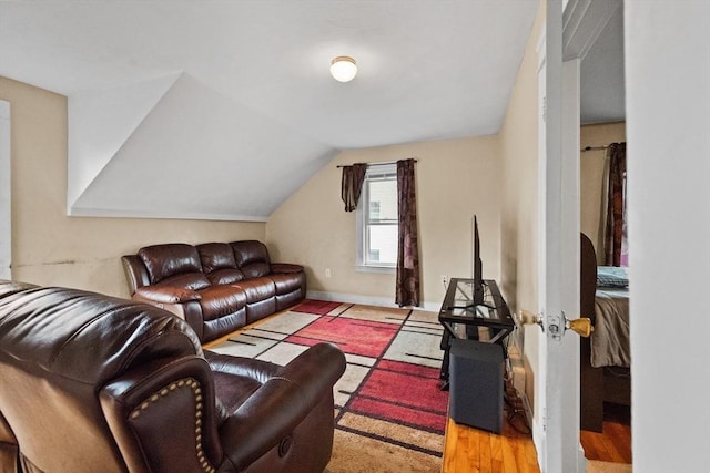 living room featuring vaulted ceiling and light hardwood / wood-style flooring