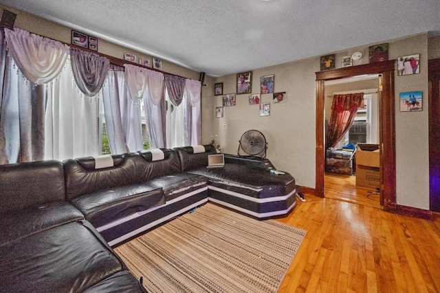 living room featuring a textured ceiling and hardwood / wood-style flooring