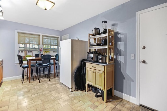 80 Brush Hill Ave Unit 33, West Springfield, MA 01089 - kitchen with baseboards, light stone finish flooring, and freestanding refrigerator