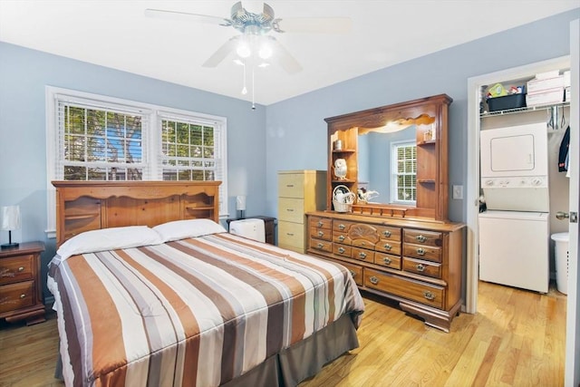 80 Brush Hill Ave Unit 33, West Springfield, MA 01089 - bedroom with stacked washer / dryer, light wood-style flooring, and a ceiling fan