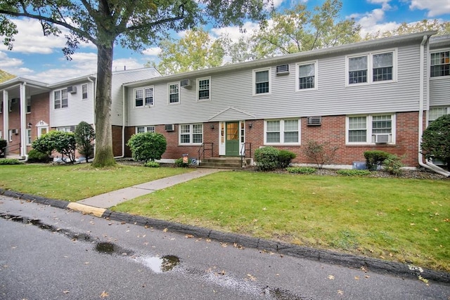 80 Brush Hill Ave Unit 33, West Springfield, MA 01089 - view of front of property with brick siding, a front yard, cooling unit, and a wall unit AC