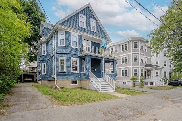 56 Marlboro St Unit 1, Belmont, MA 02478 - view of front of house featuring a balcony and a front lawn