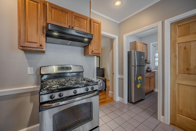 56 Marlboro St Unit 1, Belmont, MA 02478 - kitchen with appliances with stainless steel finishes, under cabinet range hood, light tile patterned flooring, baseboards, and ornamental molding