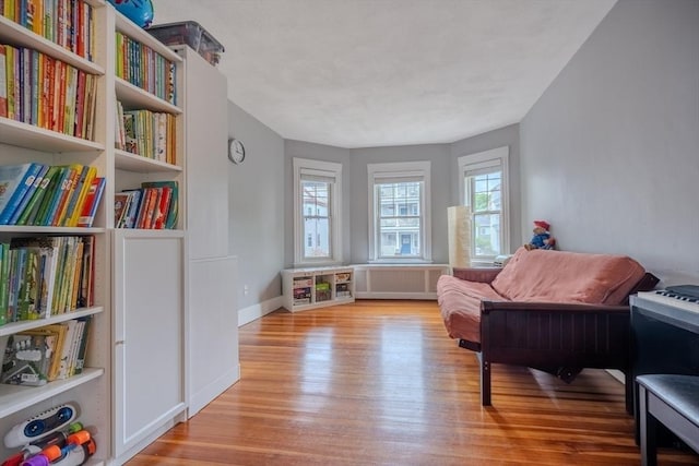 56 Marlboro St Unit 1, Belmont, MA 02478 - living area featuring light wood-type flooring, radiator heating unit, and baseboards
