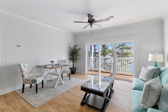 living room with light hardwood / wood-style floors, ceiling fan, and ornamental molding