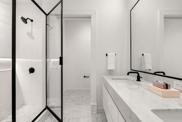 bathroom with tile patterned floors, dual bowl vanity, and an enclosed shower