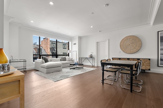 dining area with hardwood / wood-style flooring and ornamental molding