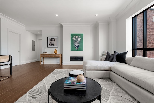 living room featuring ornamental molding, electric panel, and hardwood / wood-style floors