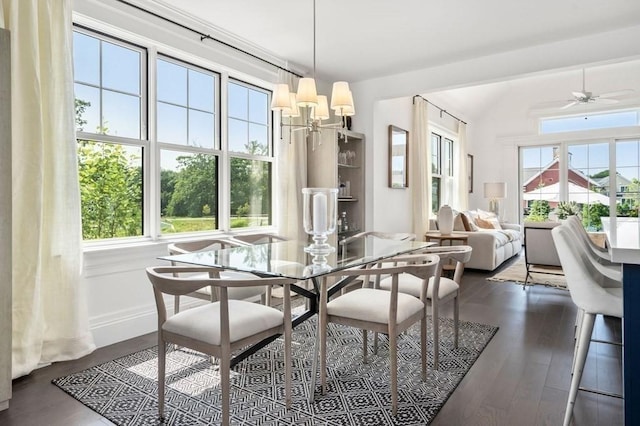 dining area with dark wood-style floors, ceiling fan, and vaulted ceiling