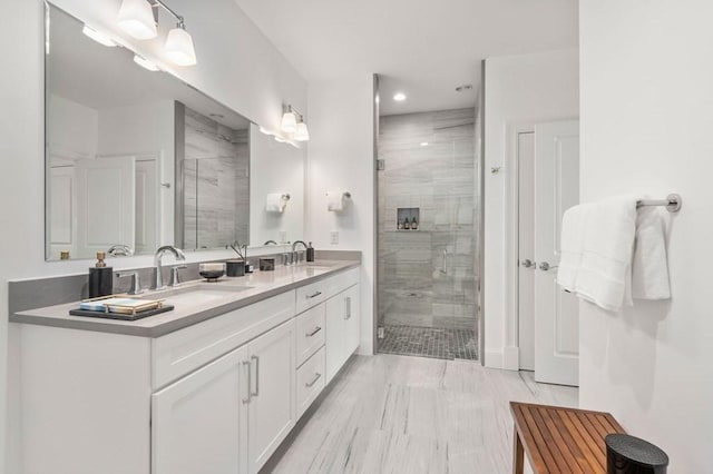 full bath with a stall shower, double vanity, and recessed lighting