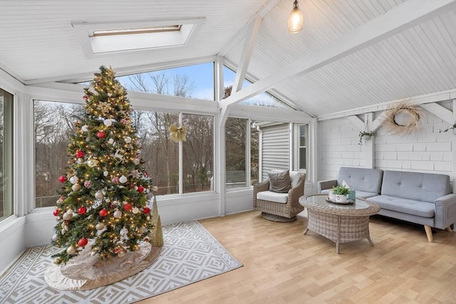 sunroom featuring plenty of natural light and vaulted ceiling with skylight