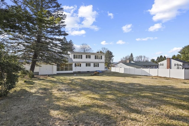 exterior space featuring fence and a garage