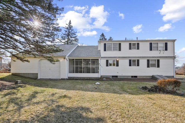 back of house with a yard, a garage, and a sunroom