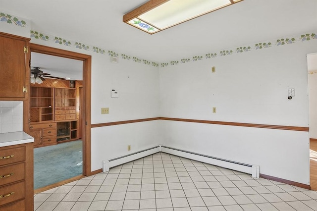 unfurnished room featuring light tile patterned floors, light carpet, a baseboard heating unit, and ceiling fan