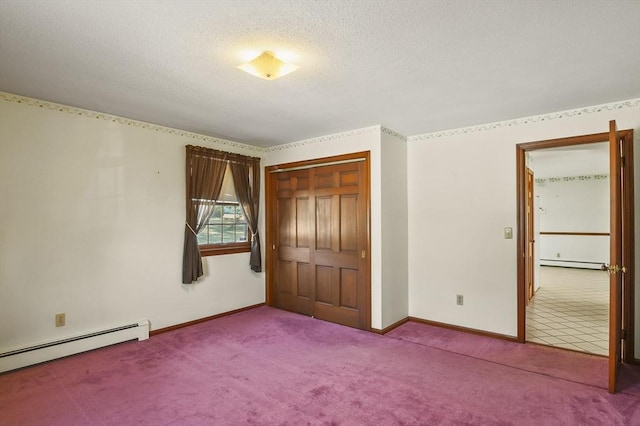 unfurnished bedroom featuring baseboard heating, a textured ceiling, a baseboard heating unit, and carpet floors