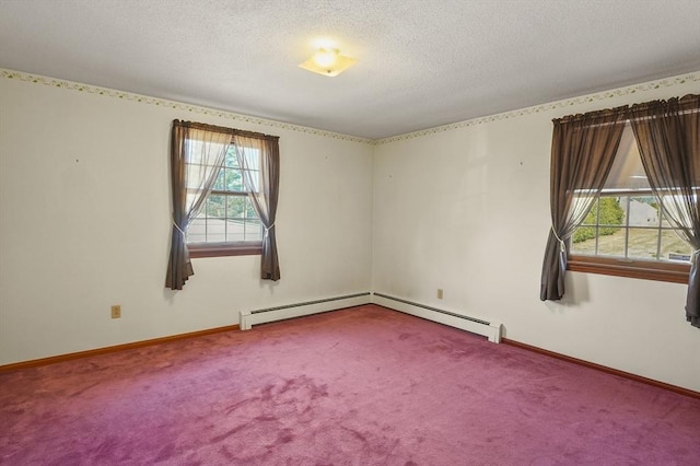 empty room featuring a baseboard heating unit, carpet, baseboards, and a textured ceiling