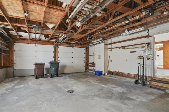 garage with white refrigerator with ice dispenser and a garage door opener