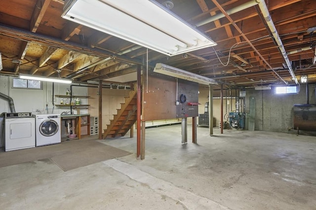 basement featuring stairway, independent washer and dryer, a heating unit, and heating fuel