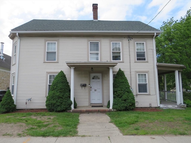 82 Main St, Blackstone, MA 01504 - view of front facade with a chimney, a front lawn, and a shingled roof