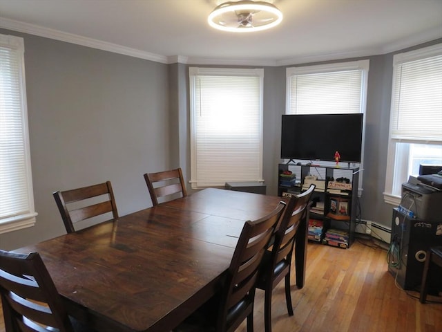 82 Main St, Blackstone, MA 01504 - dining space featuring light wood-style floors, healthy amount of natural light, crown molding, and a baseboard radiator