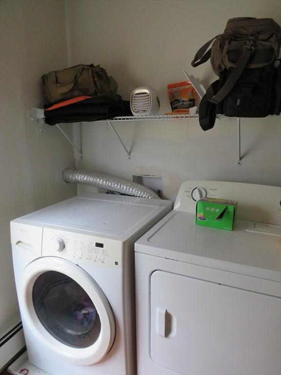 82 Main St, Blackstone, MA 01504 - washroom featuring a baseboard radiator and washer and clothes dryer