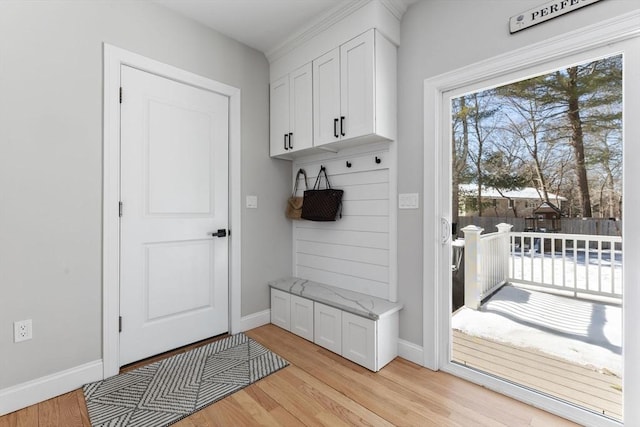 mudroom featuring light wood-style floors and baseboards