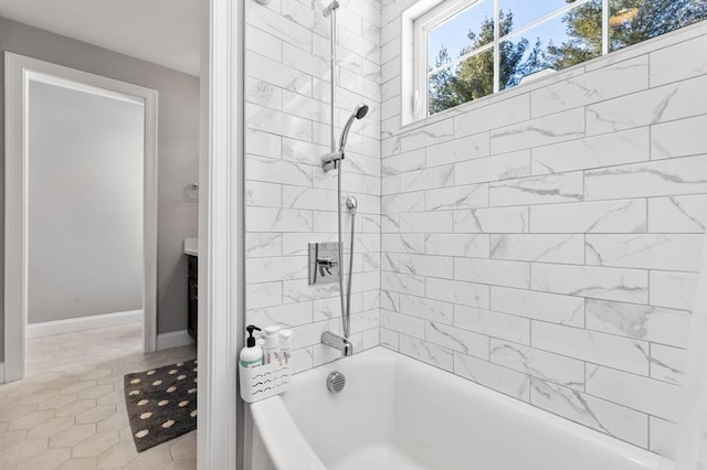 bathroom featuring baseboards and tub / shower combination