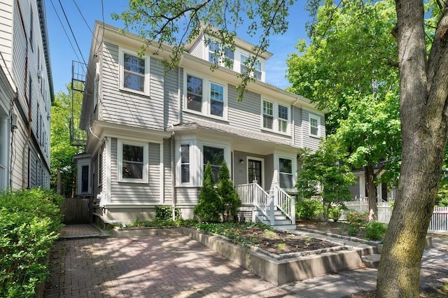 american foursquare style home with fence