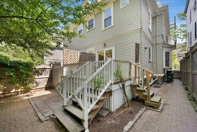 rear view of house featuring a fenced backyard and a patio