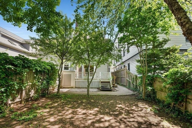 fenced backyard featuring a deck
