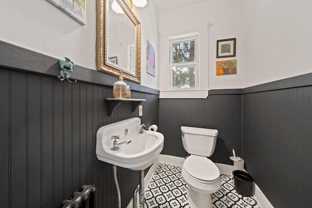bathroom with wainscoting and toilet