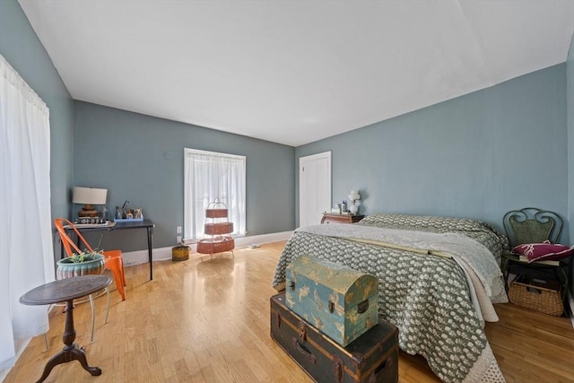 bedroom featuring baseboards and wood finished floors