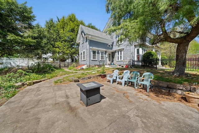 view of patio / terrace featuring fence private yard and a fire pit