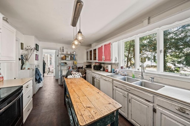 kitchen with a center island, white dishwasher, butcher block counters, and a healthy amount of sunlight