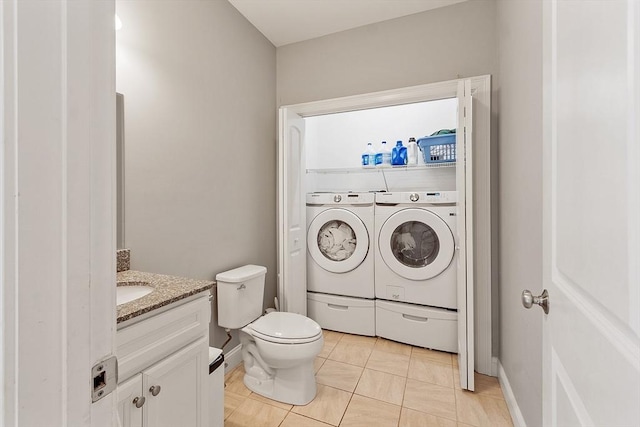 131 Great Rd, Shirley, MA 01464 - bathroom featuring separate washer and dryer, vanity, and tile patterned flooring