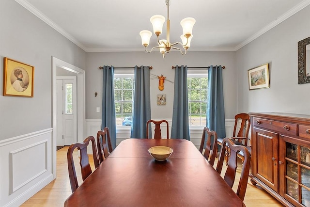 131 Great Rd, Shirley, MA 01464 - dining space featuring a chandelier, light wood-type flooring, healthy amount of natural light, ornamental molding, and a wainscoted wall